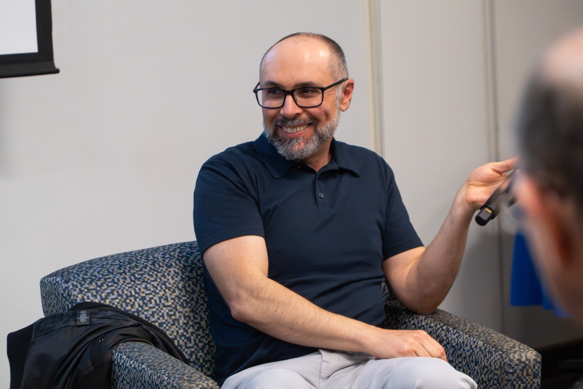 Director Yoav Potash Holding A Microphone